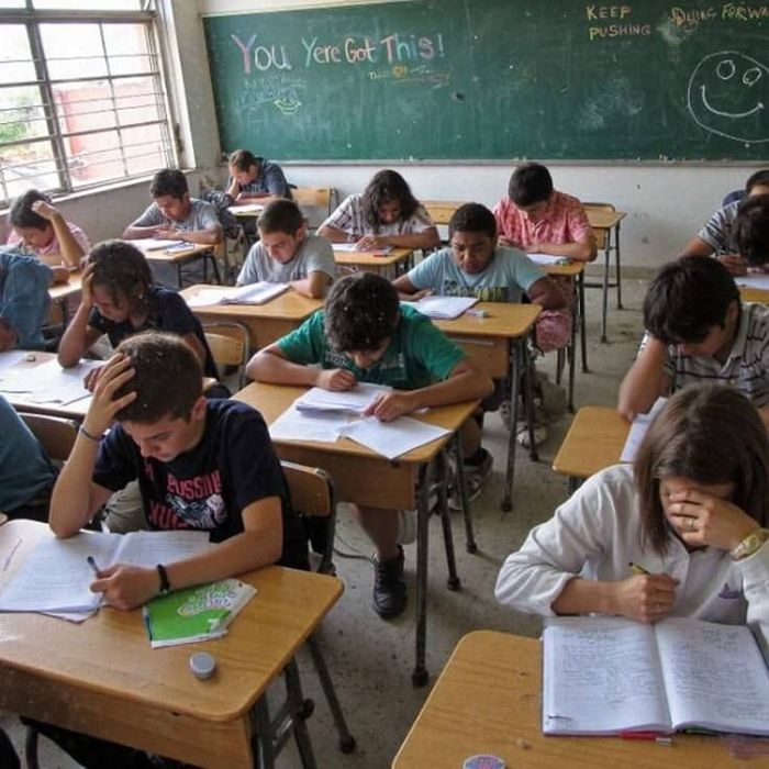 Students sitting a math exam at desks in a classroom