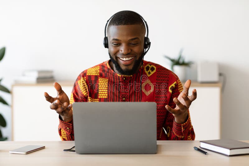 A tutor wearing a headset, teaching online from a laptop